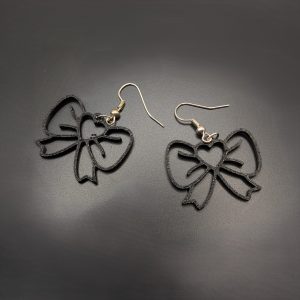 Black open bow dangle earrings with fish hook fastenings displayed on a dark background.