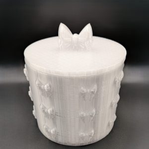 White 3D printed bow storage tub with matching lid, featuring raised bow details around the sides and a decorative bow handle. Perfect for storing jewellery, trinkets, keepsakes and small accessories.