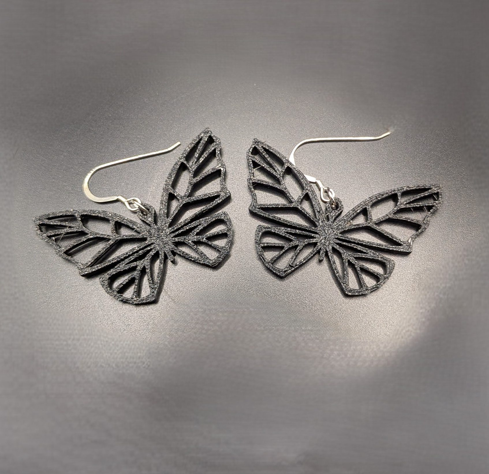 Butterfly Earrings Bitsy Boutique Black butterfly statement earrings featuring an intricate open-wing design with silver hooks.