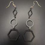 Black and silver geometric earrings featuring diamond, circle and hexagon shapes on silver fish hooks