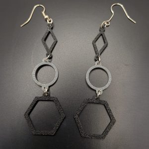 Black and silver geometric earrings featuring diamond, circle and hexagon shapes on silver fish hooks