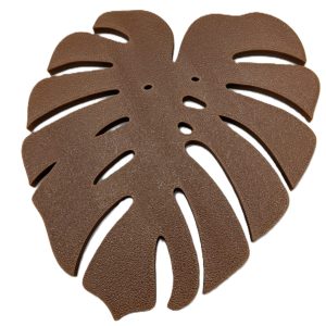 Brown monstera leaf-shaped coaster with detailed cut-out design inspired by tropical houseplants.