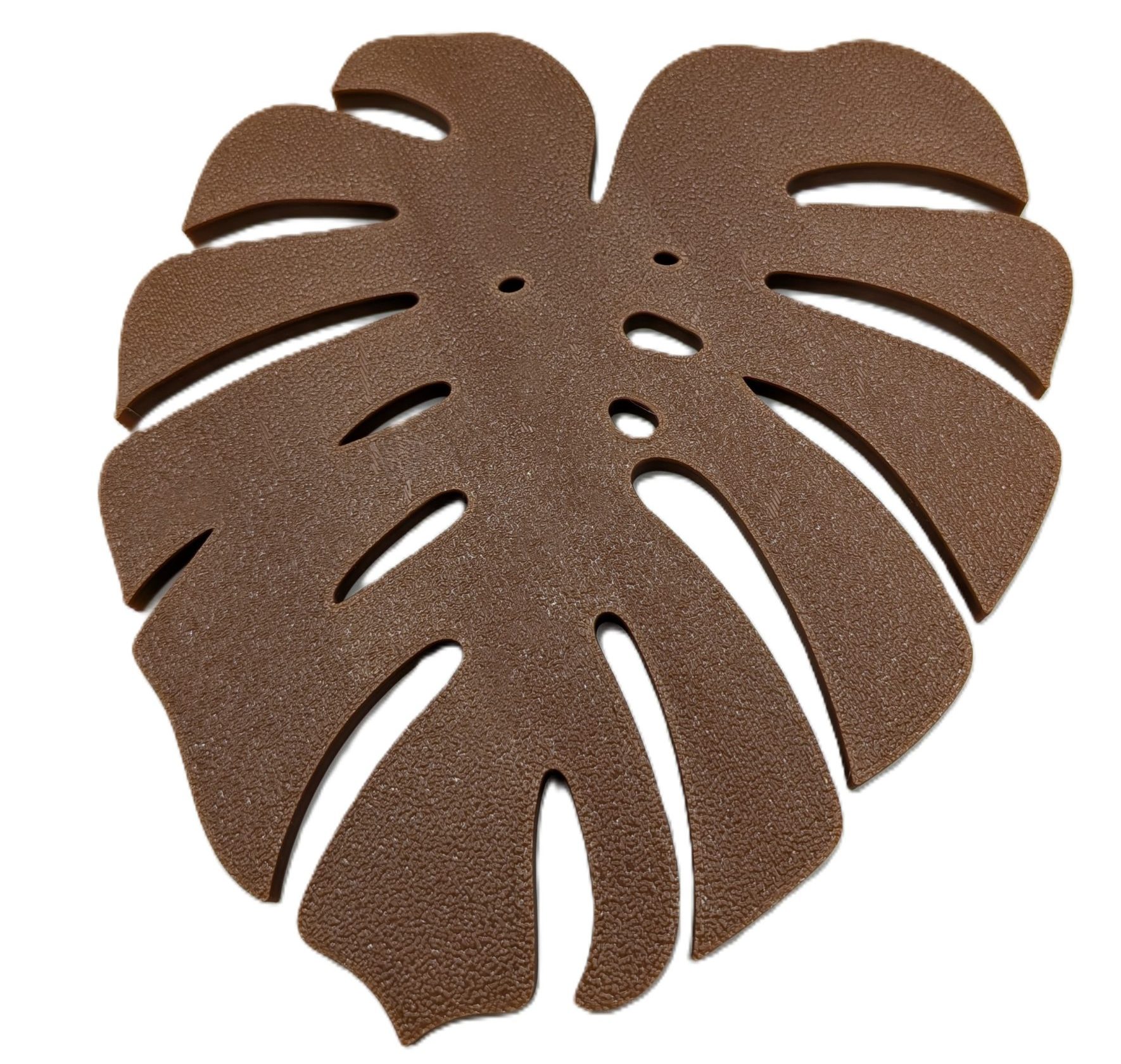 Monstera Coaster by Bitsy Boutique Brown monstera leaf-shaped coaster with detailed cut-out design inspired by tropical houseplants.