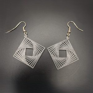 Lightweight geometric optical illusion dangle earrings featuring an intricate square spiral design with silver fish hook fastenings.