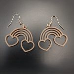 Rainbow-shaped earrings featuring heart outlines at each end, suspended from silver fish hook fastenings.