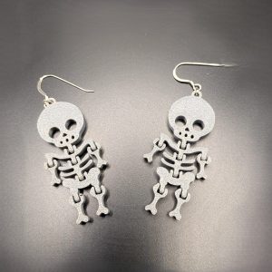 Grey skeleton drop earrings with silver hooks, lightweight gothic jewellery perfect for Halloween and alternative fashion.
