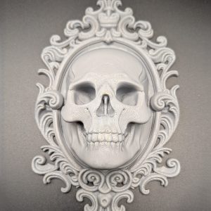 Grey 3D-printed skull gothic plaque displayed inside an ornate oval frame with decorative scrollwork